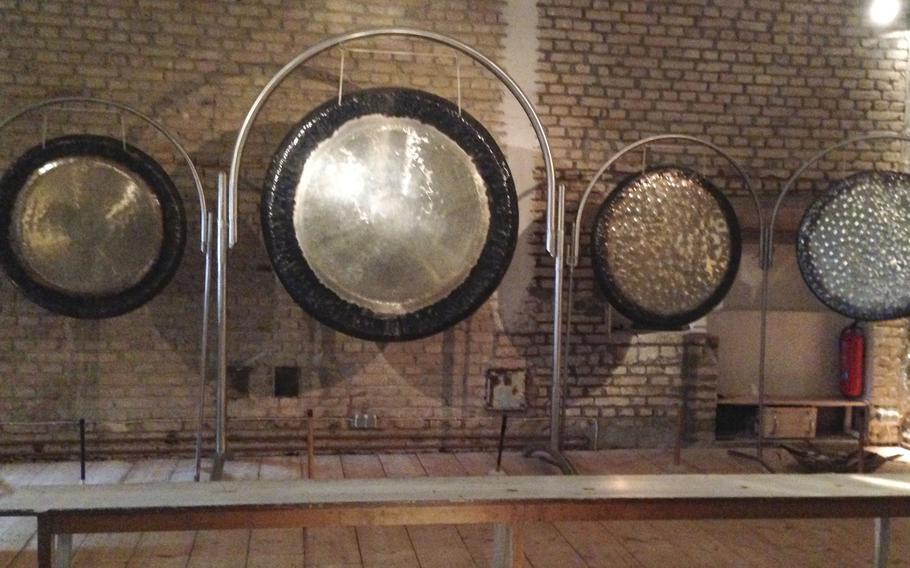 Large metal gongs on display at Schloss Freudenberg, an experiential museum in Wiesbaden, Germany. Guests are allowed to strike the gongs to see the differences size makes in the sound the gongs produce.