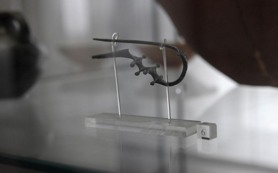 A bronze fibula, an ancient device used to fasten clothing, is displayed at the Archeological Museum of Agro Atellano in Succivo, Italy. The item was taken from an eighth century B.C. tomb excavated roughly two decades ago at the site of the U.S. Navy base in nearby Gricignano.