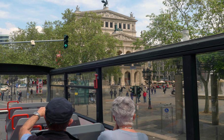From the top deck of the tour bus, tourists take a look at the Alte Oper, Frankfurt's old opera house. The concert hall opened in 1880, but was nearly completely destroyed in World War II. It stood in ruins for years, a reminder of the war, but was finally rebuilt and reopened in 1981.