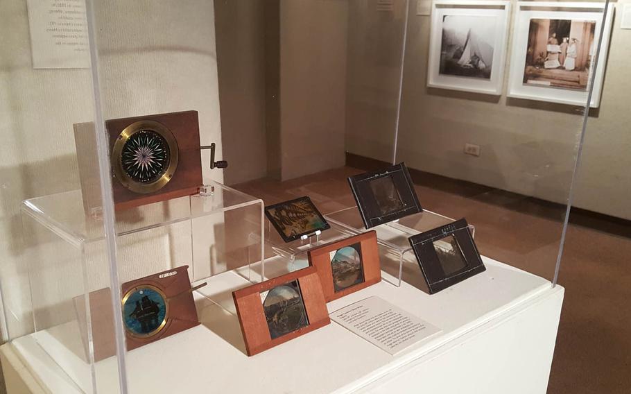In early photography, negatives were made on glass plates, such as those shown here at an exhibit at the East-West Center Gallery in Honolulu. Such plate images were used in "magic lantern" shows in China in the 1870s, a novelty at the time.
