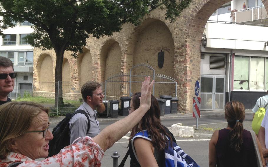 Frankfurt on Foot tour guide Nancy Shawn, left, points out features of a medieval wall that once surrounded the Jewish ghetto of Frankfurt, Germany. The tour, which lasts roughly four hours, covers hundreds of years of the city's history.