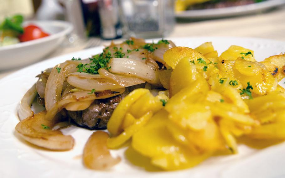 A steak with onions and roasted potatoes at Gastaette Drehpendel, a cozy restaurant in the sleepy Wiesbaden suburb of Bierstadt which offers a range of German and Italian dishes.