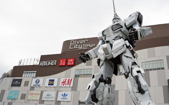 The Unicorn Gundam statue stands guard in unicorn mode outside of Diver City Tokyo Plaza in Odaiba, Tokyo, Thursday, Sept. 28, 2017.