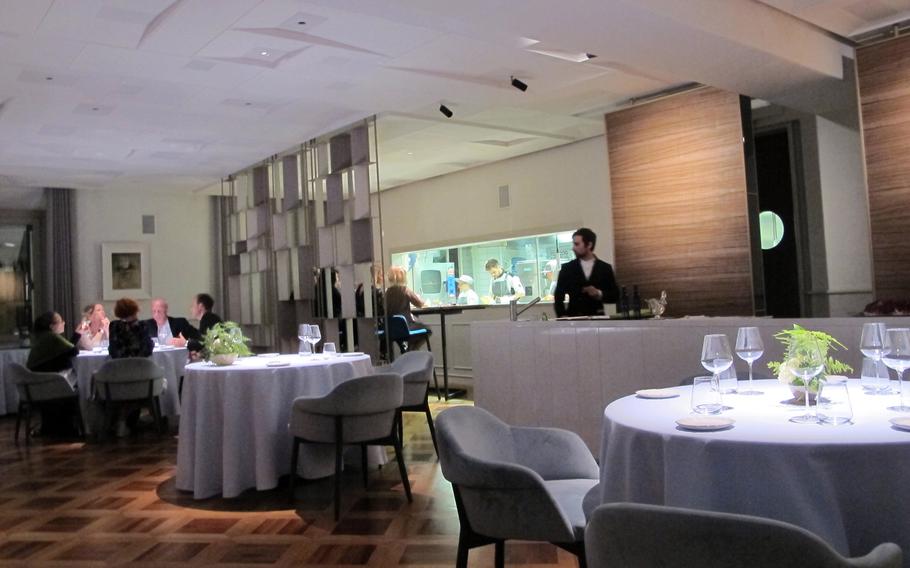 The spare dining room at El Coq, with only eight tables, contrasts with flamboyant, complicated dishes.
