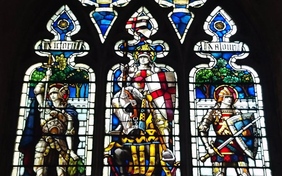 A stained glass window dedicated to fallen British soldiers of World War I at the Norwich Cathedral in Norwich, England, Tuesday, December 5, 2017.  It depicts Saint George flanked by armored figures representing victory and valor.