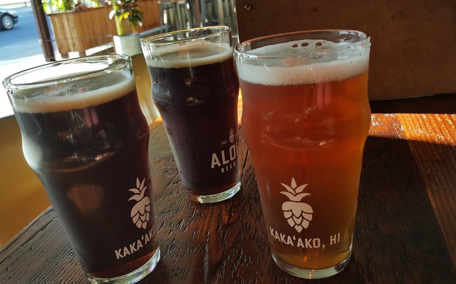 A pair of Portlock Porters stand beside a Manini India Pale Ale at Aloha Beer Company in Honolulu.