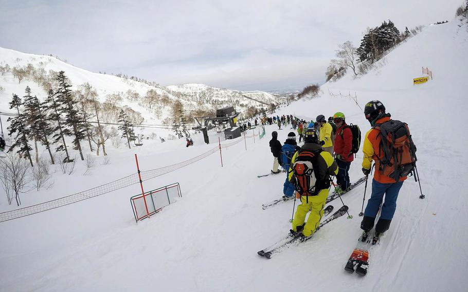 Skiers and snowboarders wait for a lift at Kagura ski resort in Niigata Prefecture, Japan.