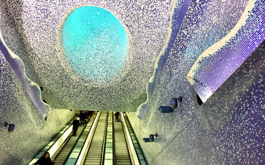 Subway-goers encounter a surreal, cavern-like mosaic that envelops the escalator at the Toledo Metro Station in Naples, Italy. It's a prime example of the artwork adorning the city's subway stations.