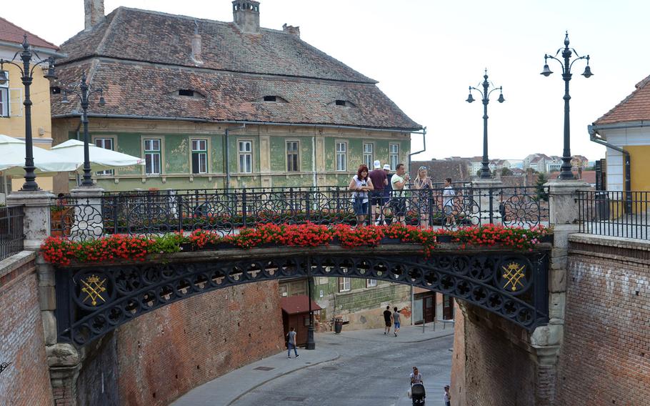 The Podul Minciunilor, or Bridge of Lies in Sibiu, Romania. It crosses over a street that leads from the upper town to the lower town. Built in 1859, it was the first wrought iron bridge in Romania.