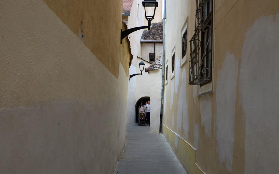 A narrow passage way makes for a shortcut between two streets in Sibiu, Romania.
