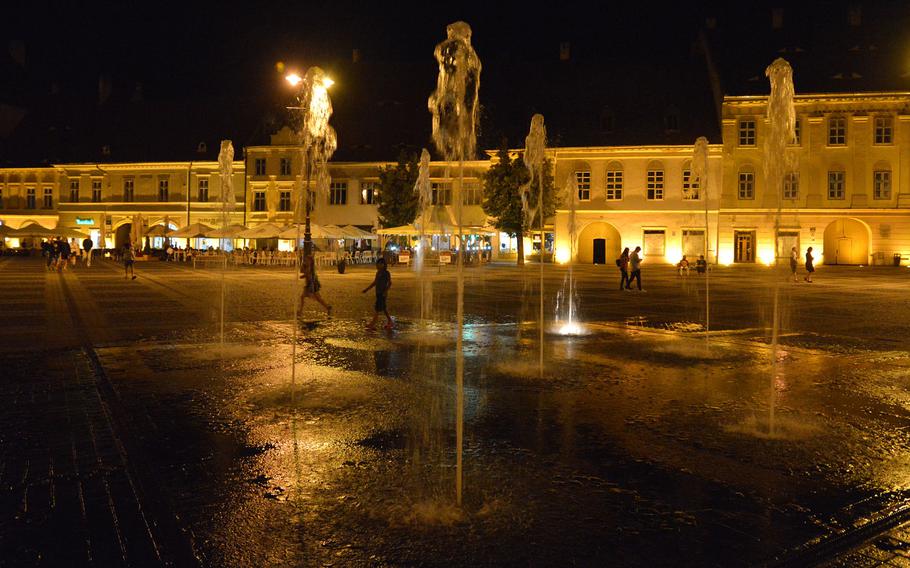 Sibiu's Piata Mare or Great Square with its fountain at night.