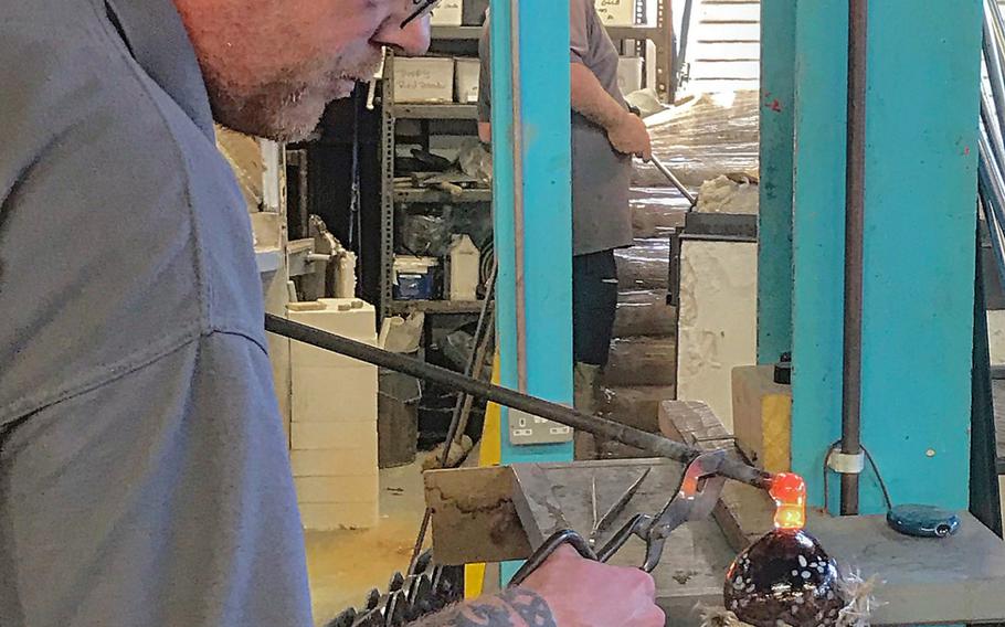 Christopher Stone works on a custom-made glass ornament at Langham Glass in Fakenham, England,  Nov. 19, 2019.