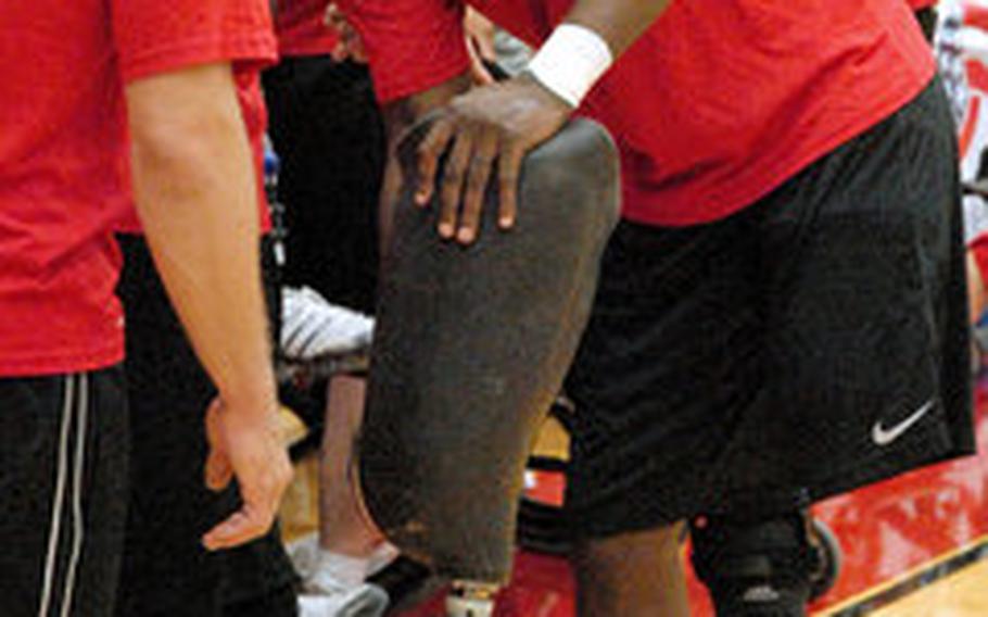 Gunnery Sgt. Marcus Wilson takes off his prosthetic leg before the gold medal match Thursday against Army in sitting volleyball at the Warrior Games in Colorado Springs, Colo. The inaugural Games brought together nearly 200 wounded servicemembers to compete in Paralympic-style events. He wears a rubber bracelet that says "courage," and over the last two and half years has become a touchstone for him. "I had this thing when I was still really weak at the time, and didn't think I'd be able to do anything," he said. "Every time I look at it now I know where I came from and where I am now." 