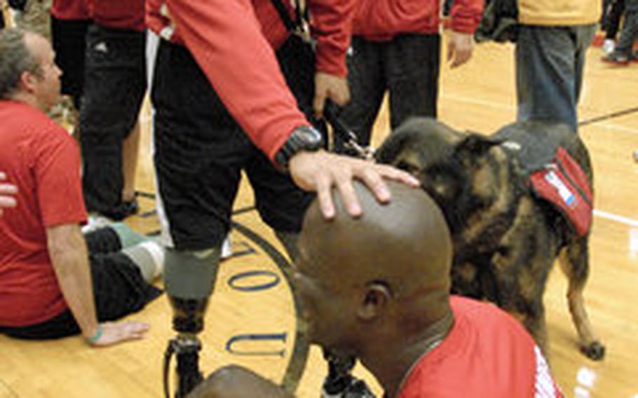 Gunnery Sgt. Marcus Wilson is congratulated by medically retired Gunnery Sgt. Angel Barcenas after winning gold in sitting volleyball at the Warrior Games last week in Colorado Springs, Colo. Barcenas, a double amputee, offered Wilson the encouragement he needed during the early days of his recovery at Walter Reed Medical Center.