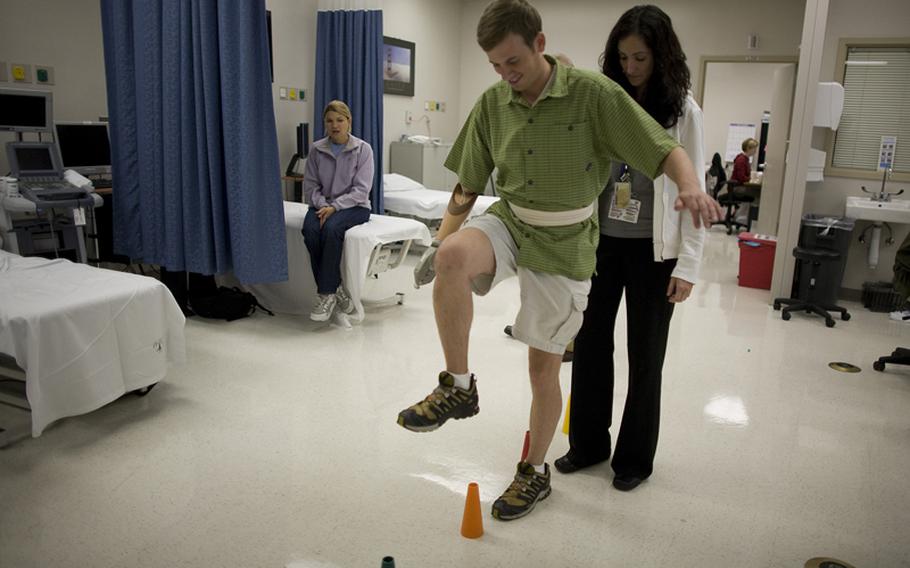 Physical therapist Kyla Dunlavey works with Sgt. Ted Wade at Walter Reed Army Medical Center in September 2007. 