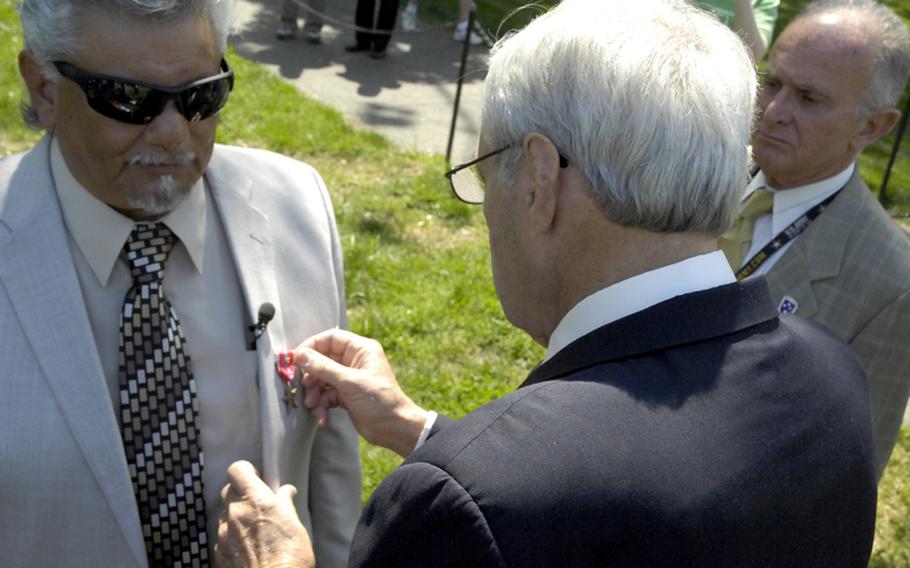 Antonio Martinez receives the Bronze Star from Vernon Sones. At right is John Iappini.