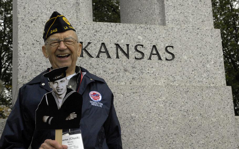 Part of the Stars and Stripes Honor Flight from Wisconsin, veteran Charles Moritz displays an older image of himself by his home state in the World War II Memorial on Nov 3, 2012.