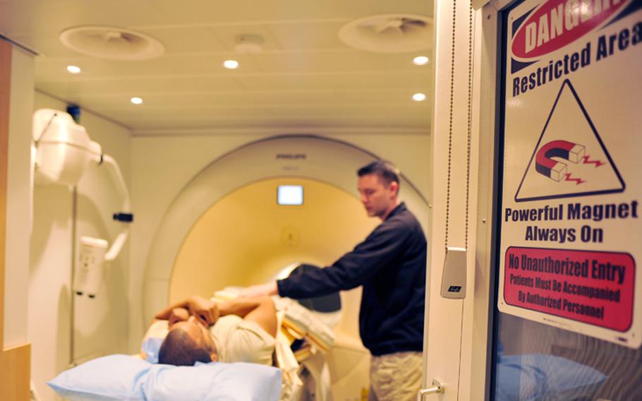 Cody Turner explains the magnetic resonance imaging process to a patient at Bagram Air Field, Afghanistan, April 3, 2012. 