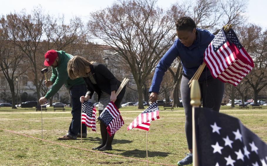 Members and supporters of Iraq and Afghanistan Veterans of America (IAVA) help plant flags on the National Mall in Washington, D.C., on March. 27, 2014. A total of 1,892 flags were planted, each representing the number of veterans and servicemembers estimated to have committed suicide so far in 2014.
