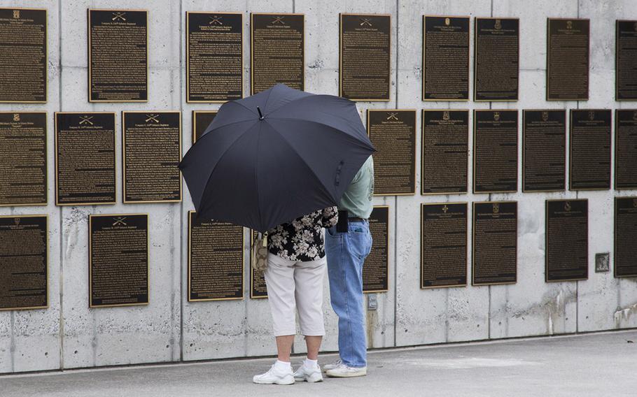 Visitors to the National D-Day Memorial in Bedford, Va., read some of the numerous narrative plaques.