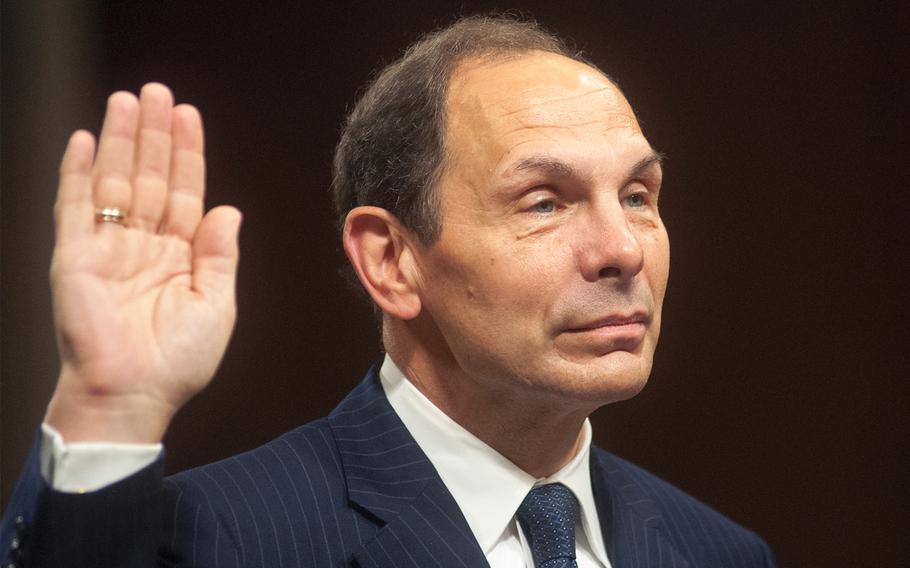 Secretary of Veterans Affairs nominee Robert McDonald raises his right hand to swear an oath before testifying before the Senate Veterans' Affairs Committee confirmation hearing, on July 22, 2014.