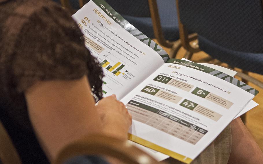 A woman reads statistics from the IAVA survey during their press conference at the National Press Club on July 24, 2014. 