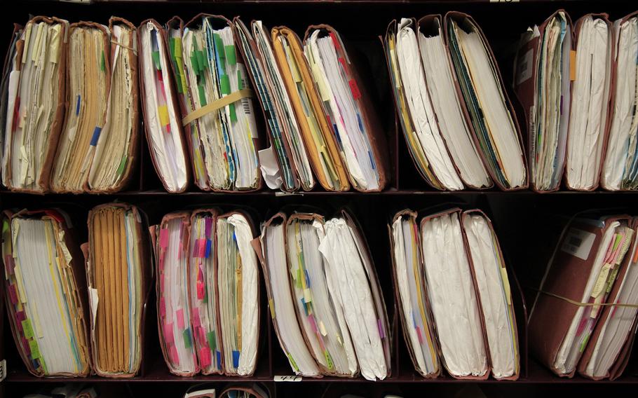 Paper files of benefits cases crowd shelves at the Department of Veterans Affairs office in Los Angeles, December 5, 2012.