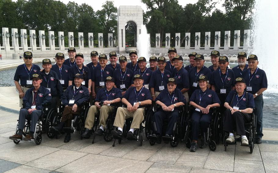 Veterans taking part in the Honor Flight of Idaho trip to Washington, D.C.pose for a photo at the National World War II Memorial, September 3, 2014.