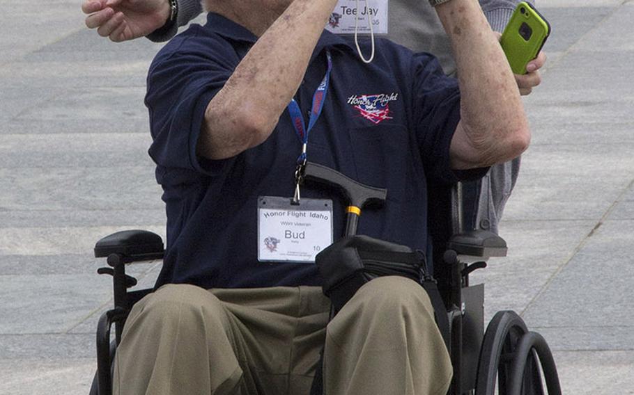 World War II veteran Bud Kelly takes a photo at the National World War II Memorial in Washington, D.C., September 3, 2014. With him is guardian T.J. Hilbert.