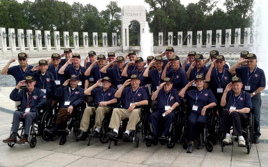 Honor Flight of Idaho veterans salute during a group photo at the National World War II Memorial in Washington, D.C., September 3, 2014.