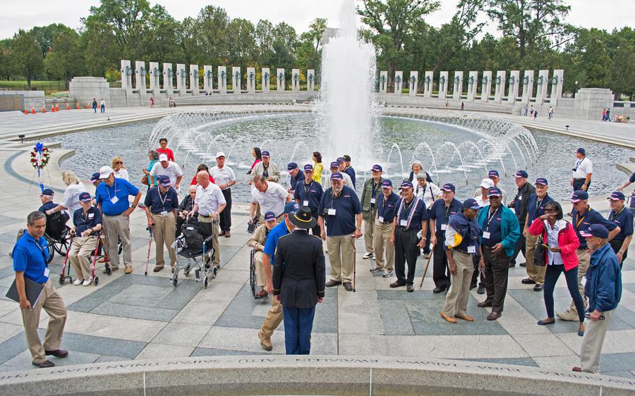 Participants of the Texas Honor Flight gather around the Pacific Theater Pavilion for a wreath laying ceremony on Oct. 1, 2014