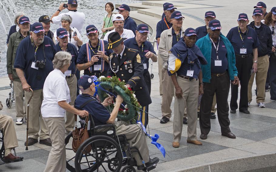 Participants in the Texas honor flight watch a wreath laying ceremony at the Pacific Theater Pavilion on Oct. 1, 2014.