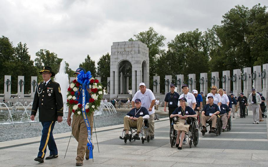 The honor flight from Lubbock, Texas, moves to the Atlantic Theater Pavilion for the second wreath laying ceremony on Oct. 1, 2014.