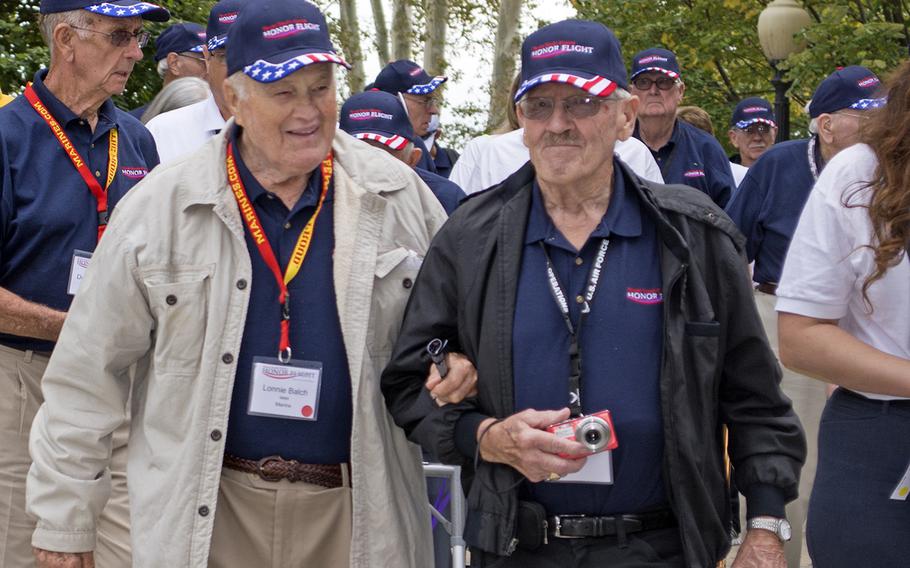 Two members of the Texas honor flight walk into the World War II Memorial on Oct. 1, 2014, in Washington, D.C.