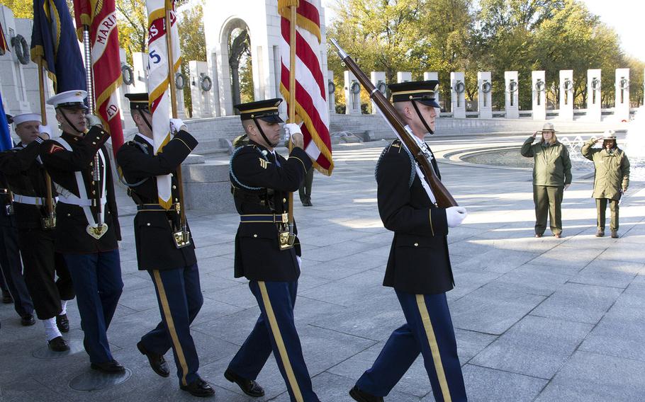 The Armed Forces Color Guard presents the colors on Veterans Day 2014 at the National World War II Memorial in Washington, D.C.