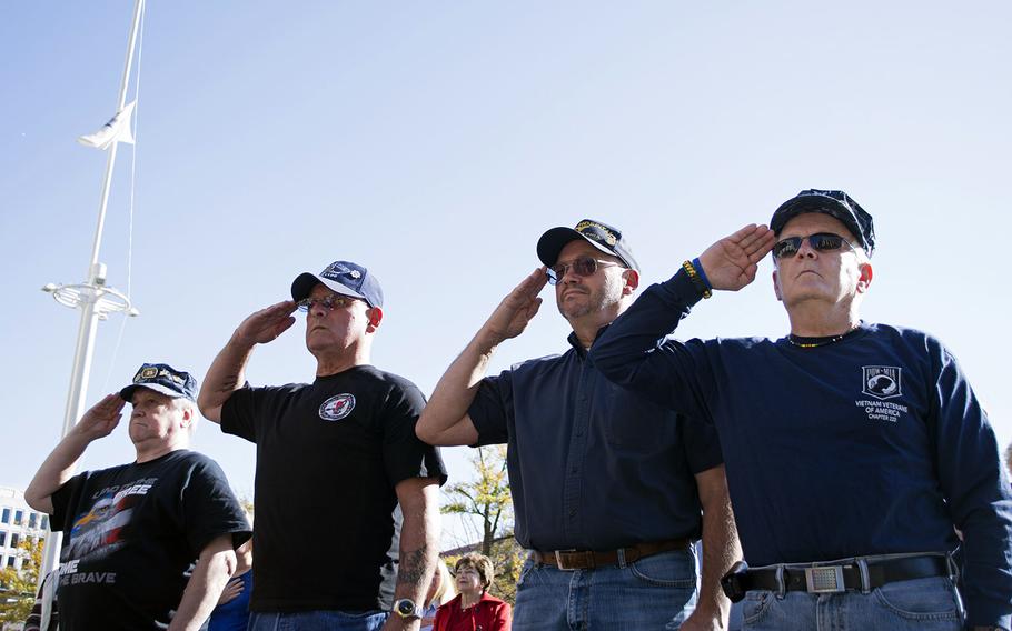 From right to left, Jim Miller, Gene Bernhardt, John Rosetti and Bob Lyons salute during a wreath-laying ceremony on Veterans Day 2014 at the U.S. Navy Memorial in Washington, D.C.