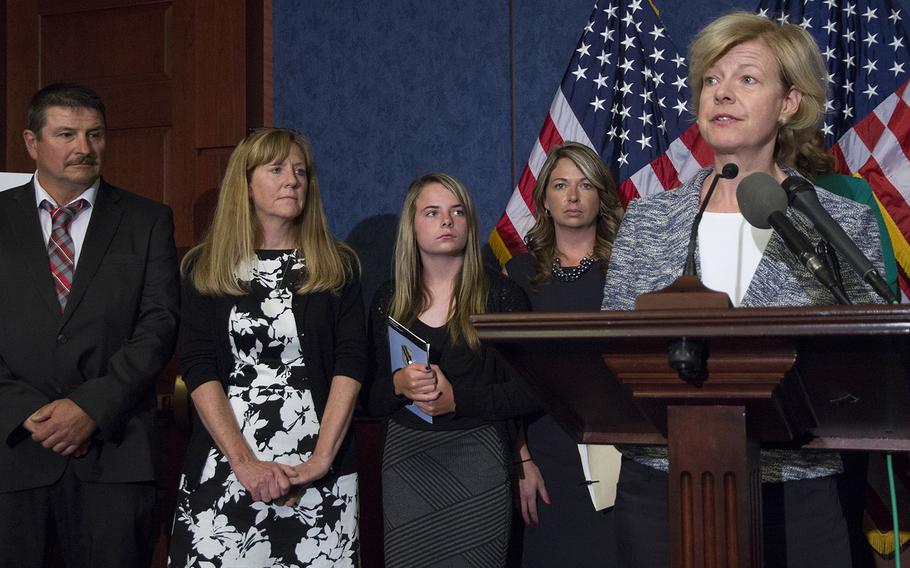 Jason Simcakoski's father, Marv; mother, Linda; daughter, Anaya; and widow, Heather listen as Sen. Tammy Baldwin, D-Wis., speaks at a press conference about the Jason Simcakoski Memorial Opioid Safety Act at the U.S. Capitol, June 24, 2015.