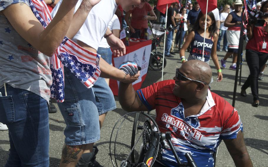 A friend greets former Marine Toran Gaal at the end of his cross-country handcycle ride that began in San Diego, California, on June 1 and ended Sunday in Arlington, Va.