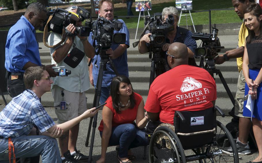 Former Marine and double amputee Toran Gaal speaks to reporters after completing a 4,000-mile handcycle journey across America Sunday at the Marine Corps Memorial in Arlington, Virginia. 