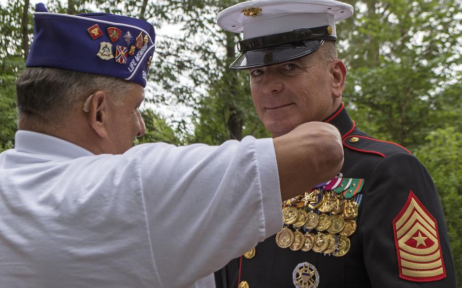 Marines help Marines, at least in this picture as a fellow Purple Heart recipient fixes something on the jacket of Senior Enlisted Advisor to Chairman of the Joint Chiefs of Staff Sgt. Maj. Bryan Battaglia before the wreath laying ceremony at Mount Vernon on Aug. 7, 2015. The ceremony was part of Purple Heart Day. 
