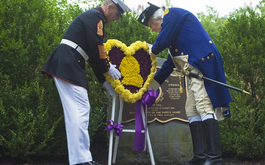 Senior Enlisted Advisor to Chairman of the Joint Staff Sgt. Maj. Bryan Battaglia places a wreath at Mount Vernon on Aug. 7, 2015, in honor of Purple Heart Day, with re-enactor Dean Malissa as George Washington.