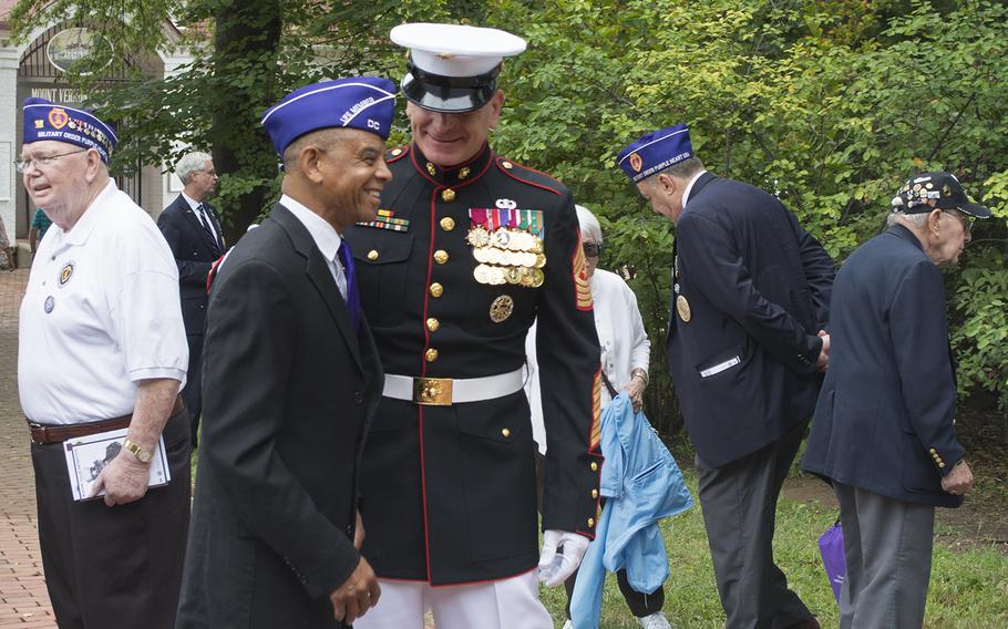 Senior Enlisted Advisor to Chairman of the Joint Chiefs of Staff Sgt. Maj. Bryan Battaglia jokes with a fellow Purple Heart recipient after the wreath laying ceremony at Mount Vernon on Aug. 7, 2015. The ceremony was part of Purple Heart Day.
