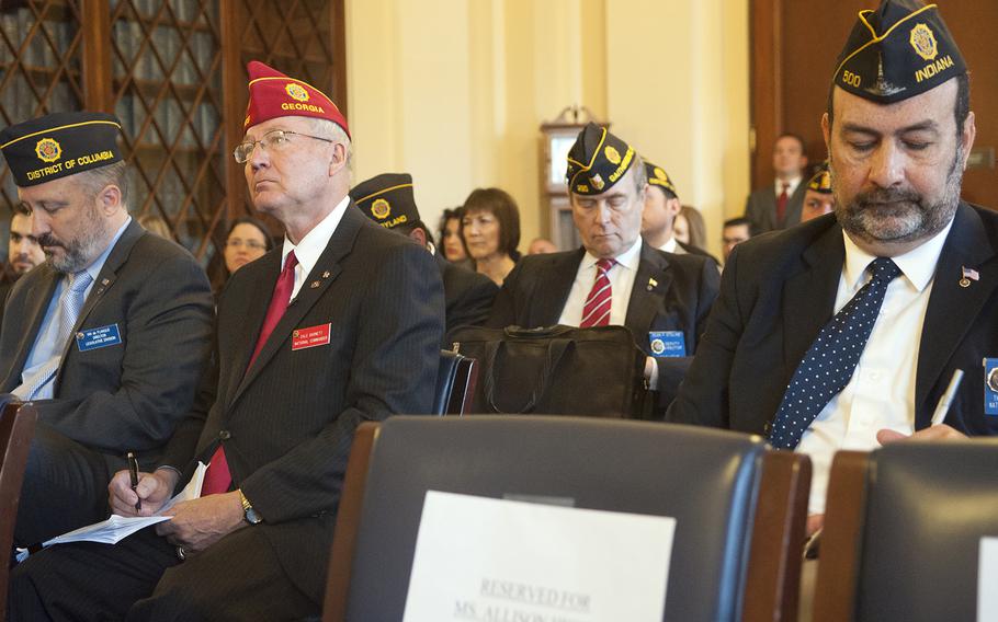 American Legion National Commander Dale Barnett, wearing the red hat at left, and other American Legion officials  take notes as they attend a House Committee on Veterans Affairs hearing on Capitol Hill in Washington, D.C., on Wednesday, Oct. 21, 2015.