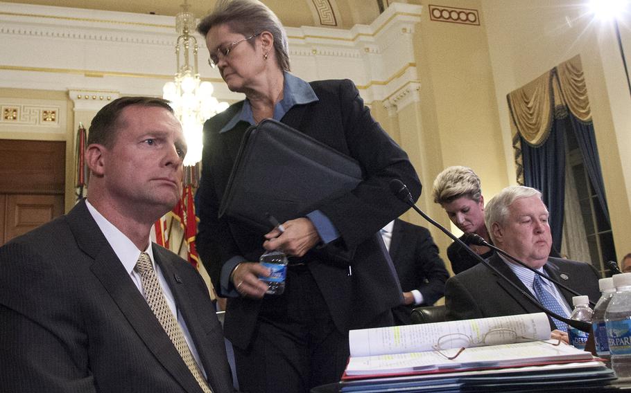 Diana Rubens, director of the Philadelphia and Wilmington regional offices of the Veterans Benefits Administration, and Kimberly Graves, background, director of the St. Paul regional office, get up to leave a House Veterans Affairs Committee hearing on alleged misuse of the VA relocation program, Nov. 2, 2015. Chairman Rep. Jeff Miller, R. Fla, dismissed the two after they invoked their Fifth Amendment rights during questioning. At left is Robert McKenrick of the Los Angeles regional office; at right is Principal Deputy Under Secretary for Benefirs Danny Pummill.