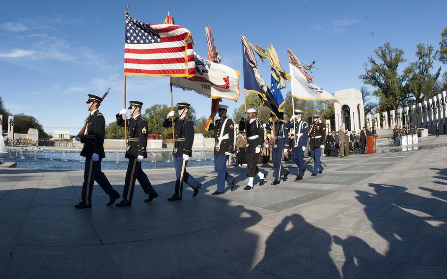 The Armed Forces Color Guard retires the colors after the playing of the national anthem to begin a Veterans Day ceremony at the National World War II Memorial in Washington, D.C., Nov. 11, 2015.