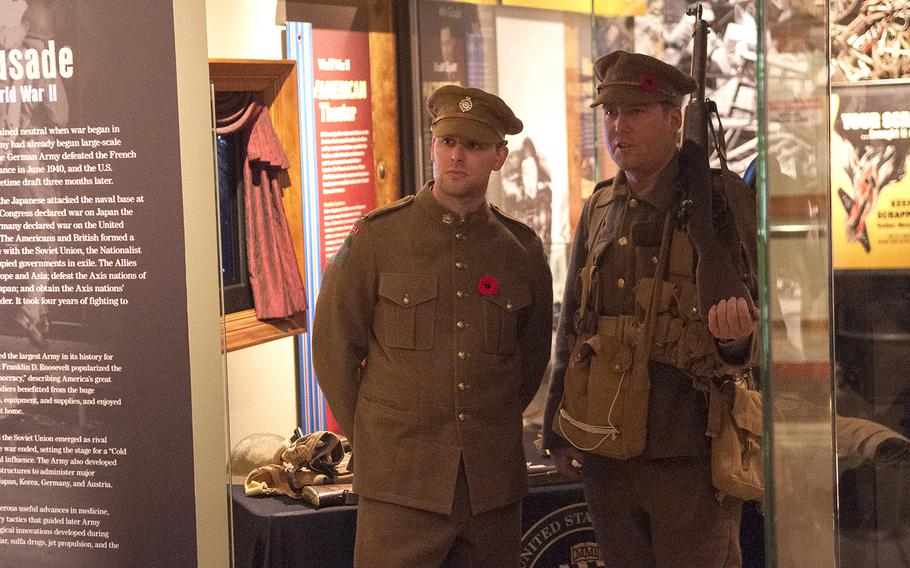 Re-enactors Rob Giunta of Redding, Pa., left, and Alex Leggatt of London, Ontario, Canada, stand their posts at a gallery within the war museum at the Army Heritage and Education Center in Carlisle, Pa., on Tuesday, Nov. 10, 2015. World War I re-enactors -- representing U.S., Canadian and French forces-- were part of a tribute to Veterans Day that centered on the reading of the iconic WWI poem "In Flanders Field."  Giunta and Leggatt were representing Canadian troops who served in the Princess Patricia's Canadian Light Infantry Regiment.
