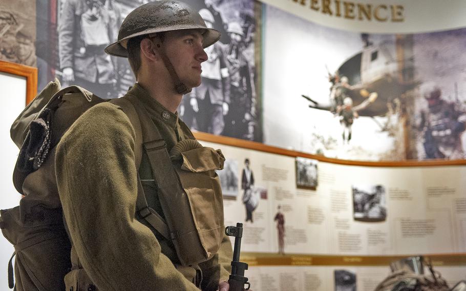 Tristan Holley of East Hanover, Pa., stands his post at a gallery within the war museum at the Army Heritage and Education Center in Carlisle, Pa., on Tuesday, Nov. 10, 2015. World War I re-enactors -- representing U.S., Canadian and French forces-- were part of a tribute to Veterans Day that centered on the reading of the iconic WWI poem "In Flanders Field."  Holley was part of a group representing the 79th Infantry Division's 304th Engineer Combat Battalion.