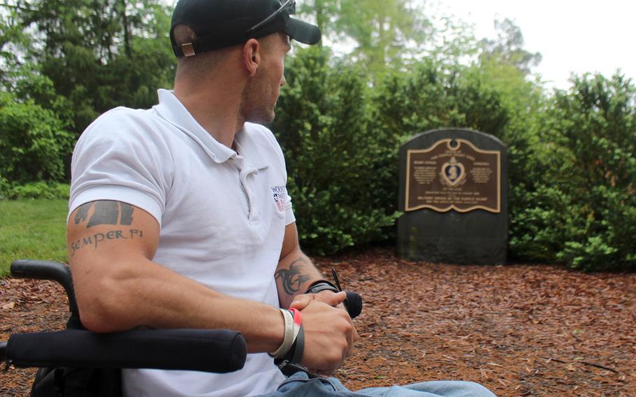 Marine Corps veteran Lance Cpl. Tyler Hoffman looks at the Purple Heart Monument in Mount Vernon, Va., the home of George Washington. Hoffman will travel cross country promoting the Purple Heart Run until the end of May.
