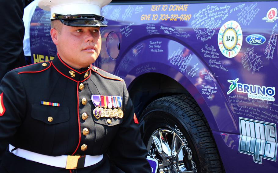 Lance Cpl. Nicholas Thom was honored by the Military Order of the Purple Heart and Wounded Warrior Family Support, and received a  mobility-equipped, 2015 Ford F-150 Super Cab Saturday at the Marine Corps War Memorial in Arlington, Va.