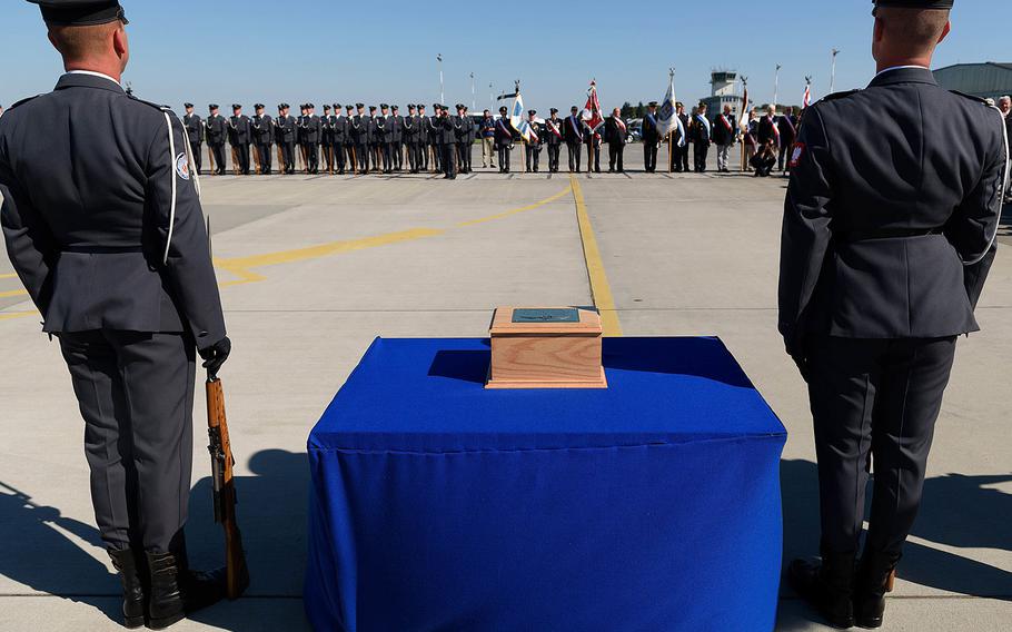 A wooden urn with the ashes of Polish fighter ace Capt. Kazimierz Sporny, credited with downing at of least five enemy planes in the Battle of Britain, is greeted with military honors at the Krzesiny Air Base in Poznan, Poland on Thursday, August 25, 2016.